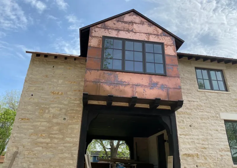 Copper metal panel facade on a stone building for Metal Roof Coating in Seabrook